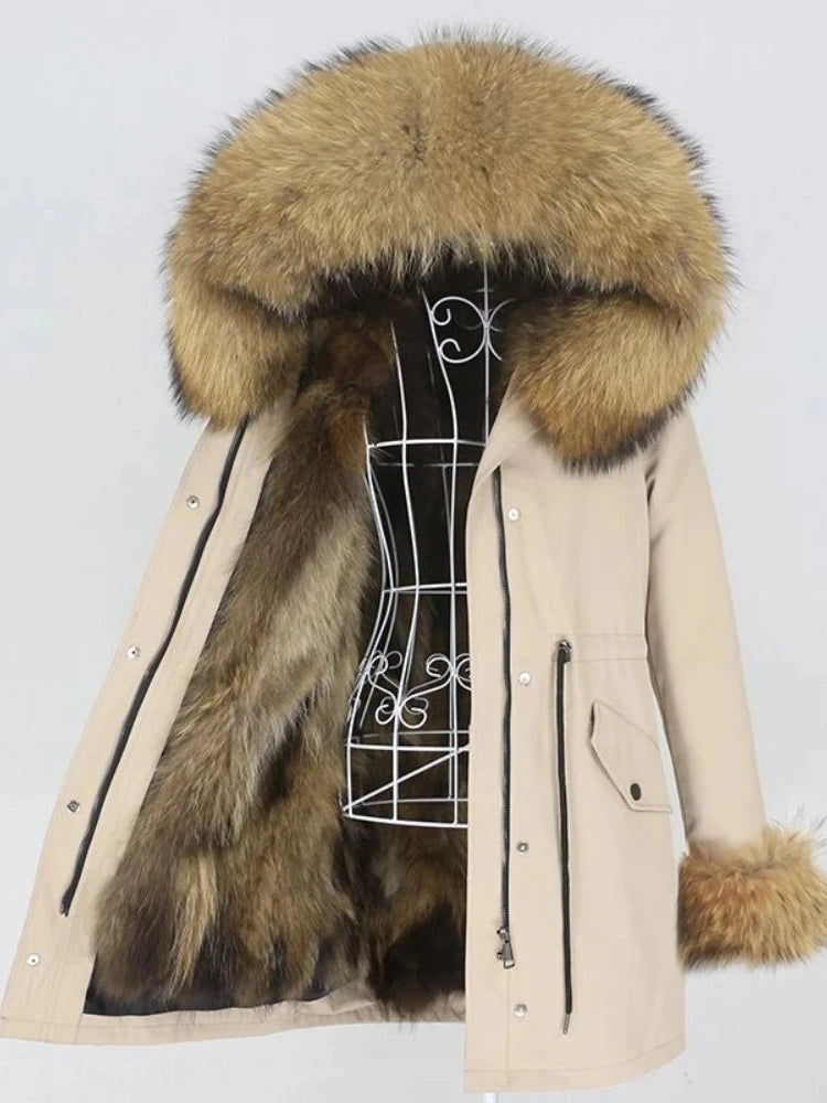 Beige parka with large fur hood on a mannequin against a white background