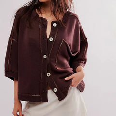Brown jacket with button details on a plain background