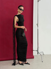 Side view of a black pleated sleeveless maxi dress