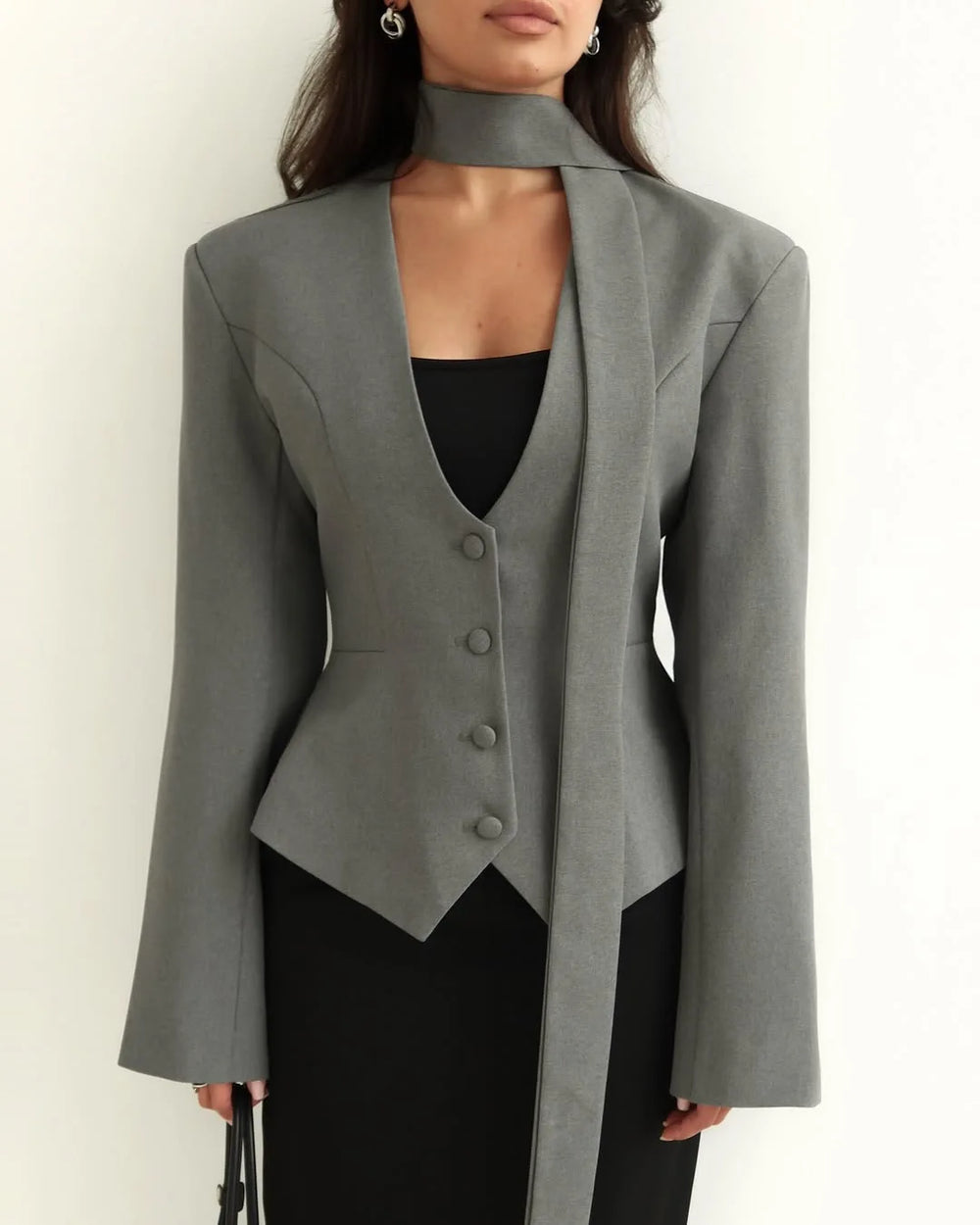 Gray blazer worn by a person on a white background