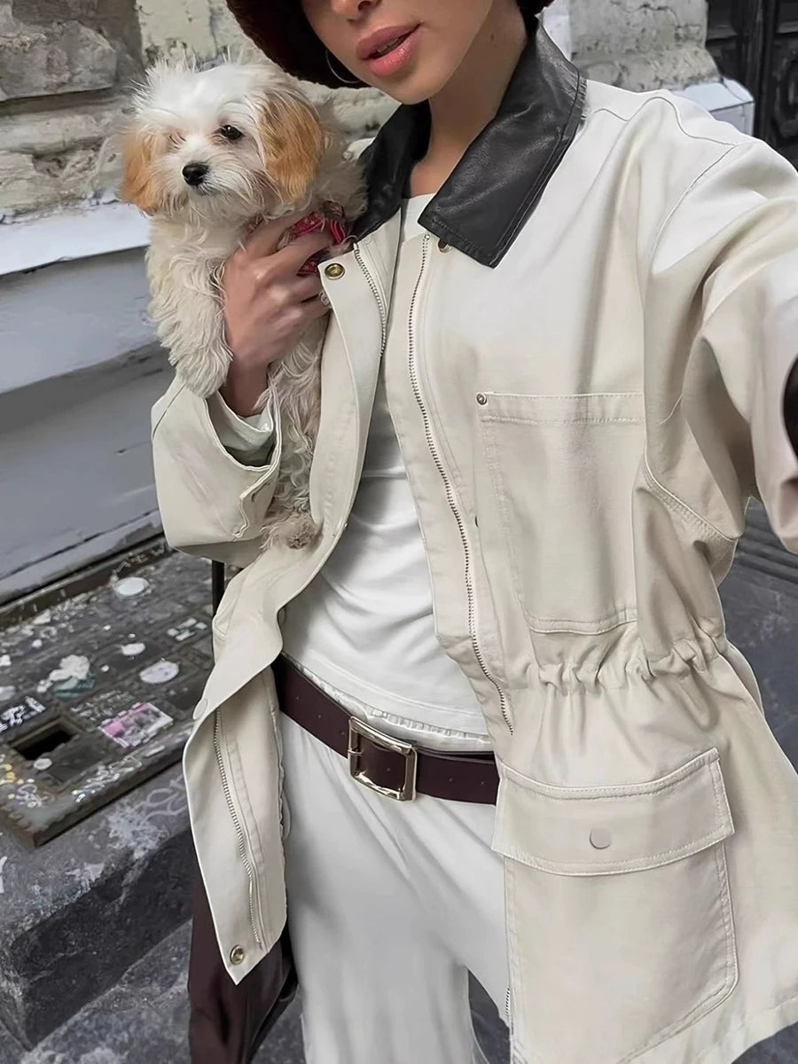 Model wearing drawstring waist utility jacket with a dog