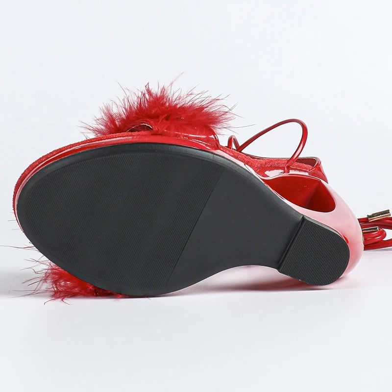 Red sandal with feather details on a white background