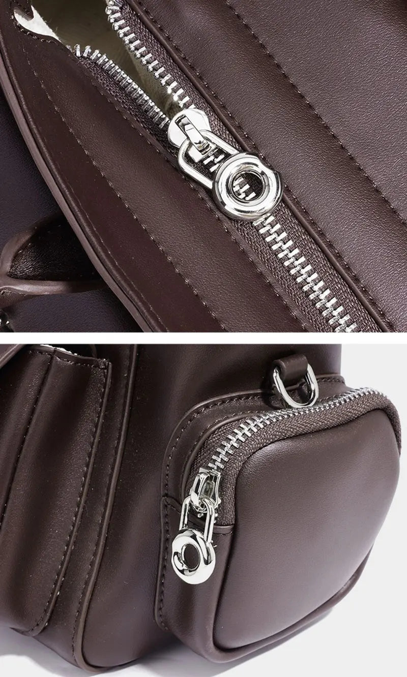 Close-up of a brown bag with a silver zipper on a white background