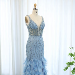 Mannequin displaying A glamorous blue mermaid evening gown with delicate feather accents and a V-neckline. Golden Atelier 4