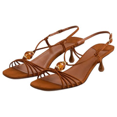 Brown suede slingback heels with beaded embellishments and a square toe.