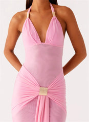 Pink halter neck dress with a gold accent on a white background