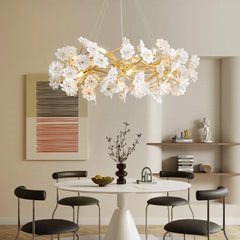 Modern chandelier with white floral design in a dining room setting.