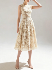 Woman in a sleeveless lace midi dress striking a pose
