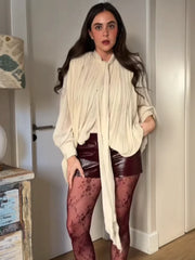 Lifestyle shot of high neck asymmetrical pleated chiffon blouse