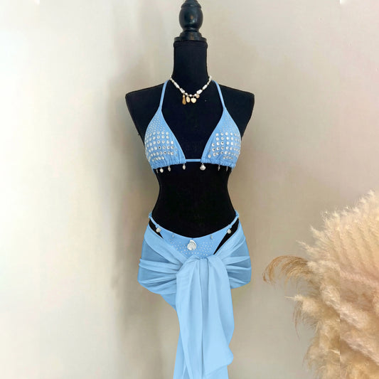 Light blue embellished bikini top with sparkling accents and chiffon wrap skirt.