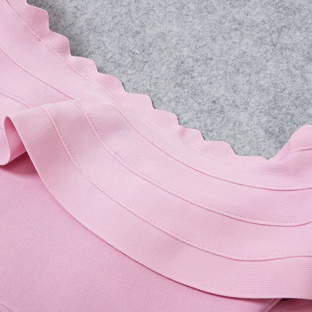 Close-up of pink fabric with a textured gray background