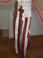 Person wearing red and white striped wide leg trousers.