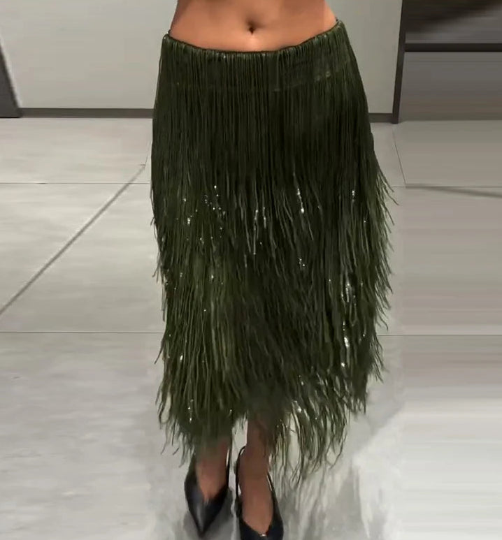 Green fringe skirt worn by a person on a neutral background