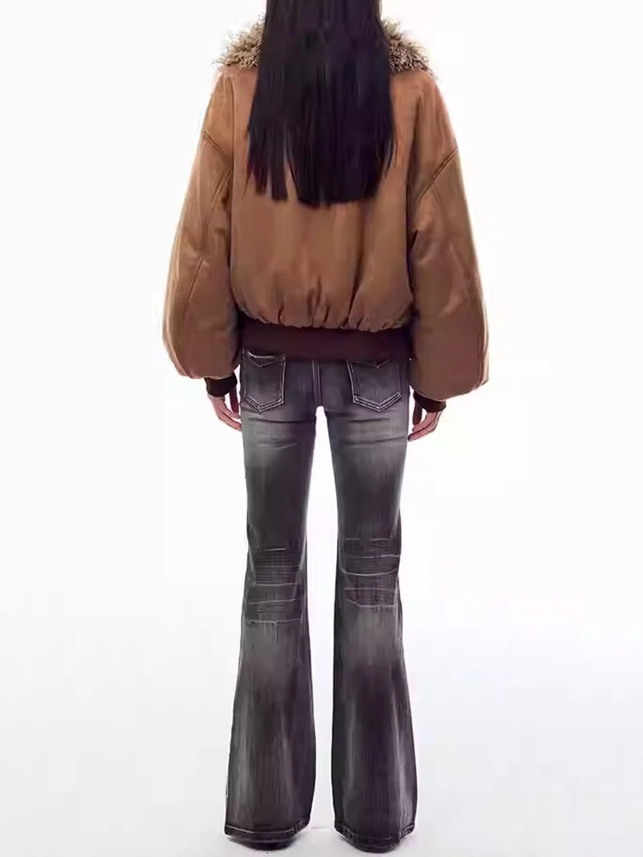 Person wearing a brown jacket and dark jeans