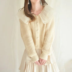 Woman wearing a Peter Pan Collar Spliced Knitted Sweater 