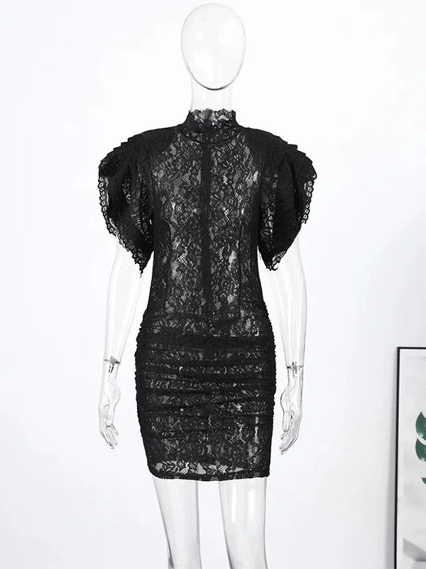 Black lace dress on a mannequin against a white background