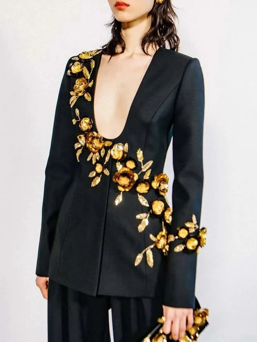 Black blazer with gold floral embroidery on a plain background