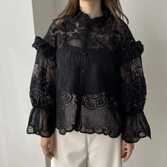 Women's lace top with embroidery and a strap detail.