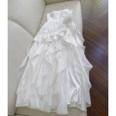 Strapless ruffle trim dress draped on a sofa