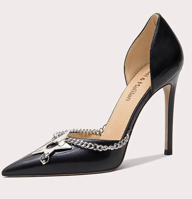 Black high-heeled shoe with chain detail on a light gray background