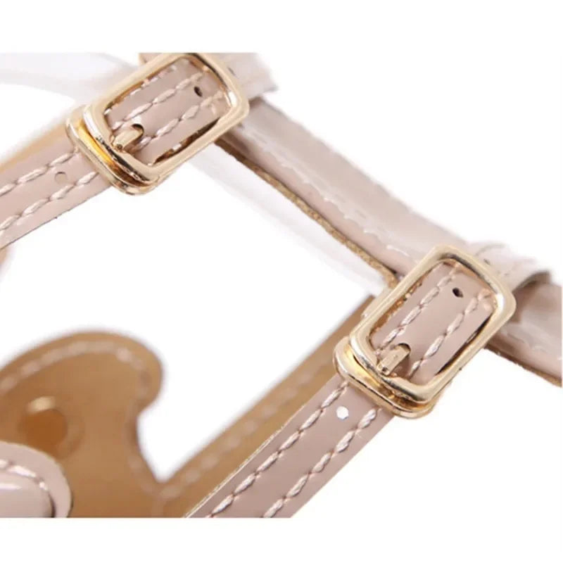 Close-up of double buckle strap on gold stiletto heel