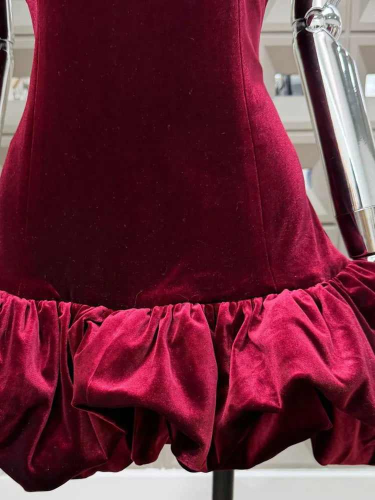 Red velvet dress on a mannequin with a blurred indoor background