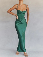 A woman wearing an elegant evening gown in green and light blue colours is in the background.