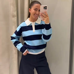 Model wearing brown and pink striped knit polo top