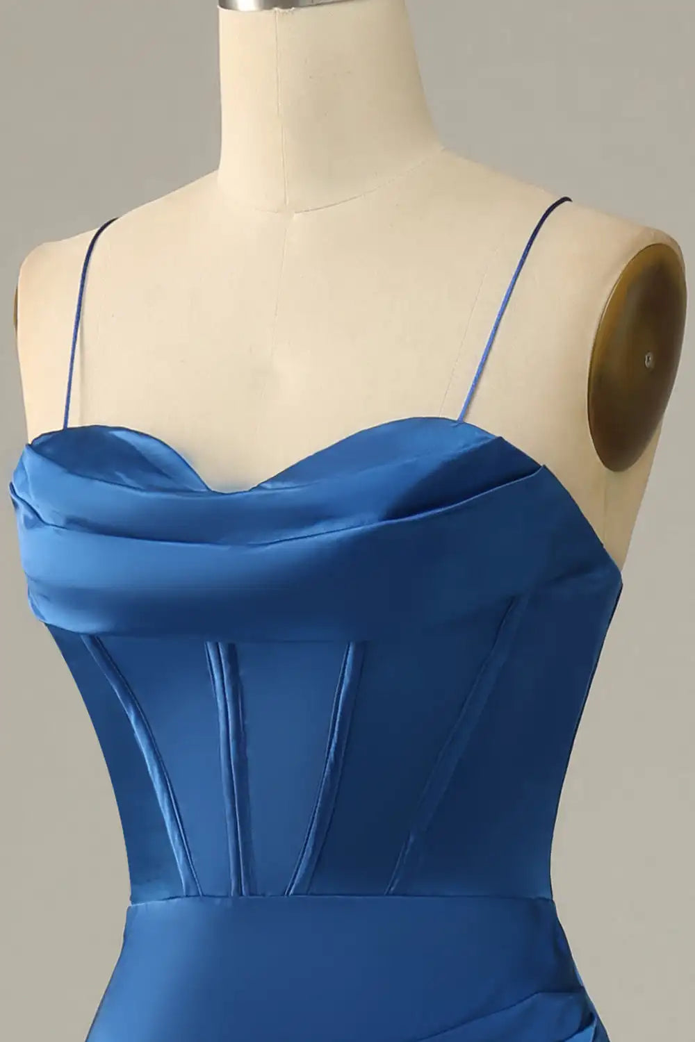 Blue dress on a mannequin against a gray background