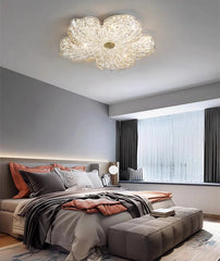 Modern bedroom with a decorative ceiling light fixture.