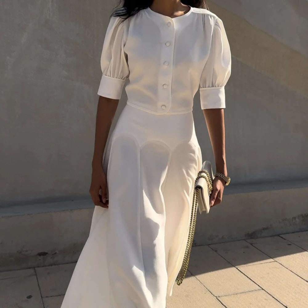 Woman wearing a white outfit with a plain background