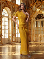 Woman in a gold dress standing in an ornate, gold-detailed room.