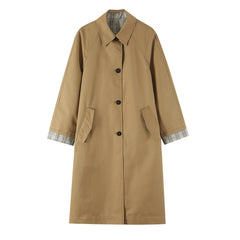 Reversible coat with plaid lining, lapel collar, and button closure.