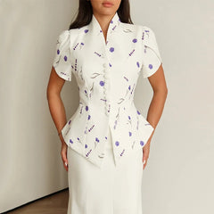 Woman wearing a white floral dress against a plain background
