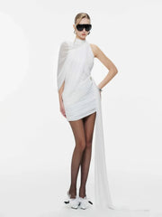 Woman wearing a white dress with a long train on a white background