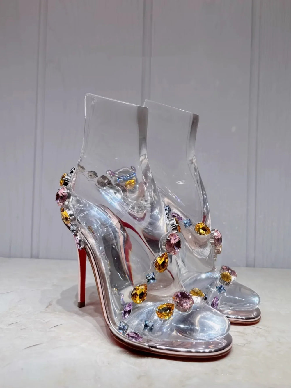 Close-up of gemstone transparent stiletto heels on display
