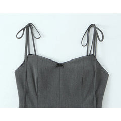 Gray dress with thin straps on a light blue background