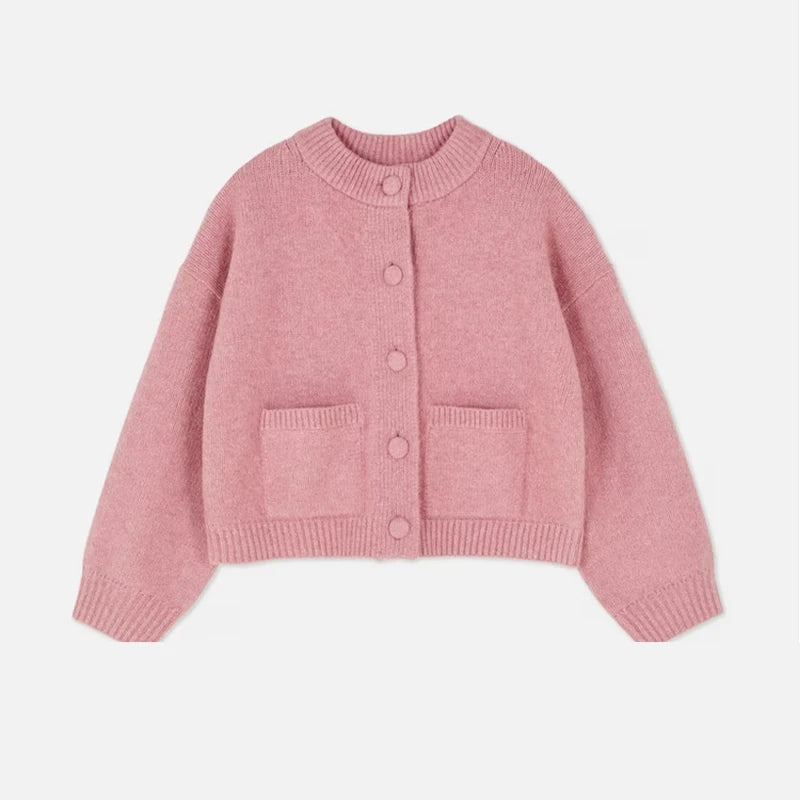 Pink knitted cardigan on a light gray background