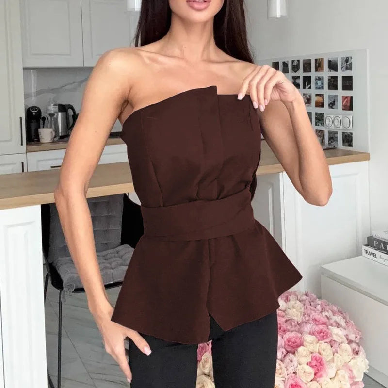 Model wearing a brown strapless peplum top