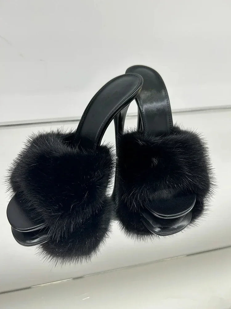 Black fur slide heels with black sole and stiletto heel