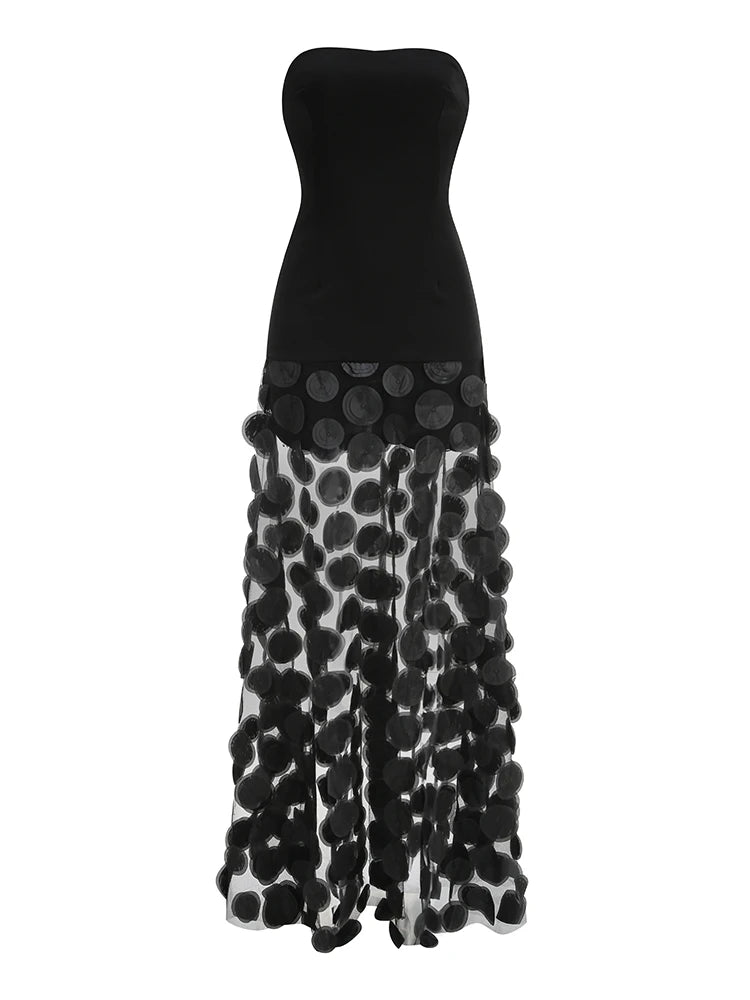 Black strapless gown with floral patterned skirt on a white background