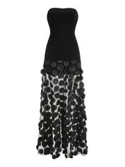 Black strapless gown with floral patterned skirt on a white background