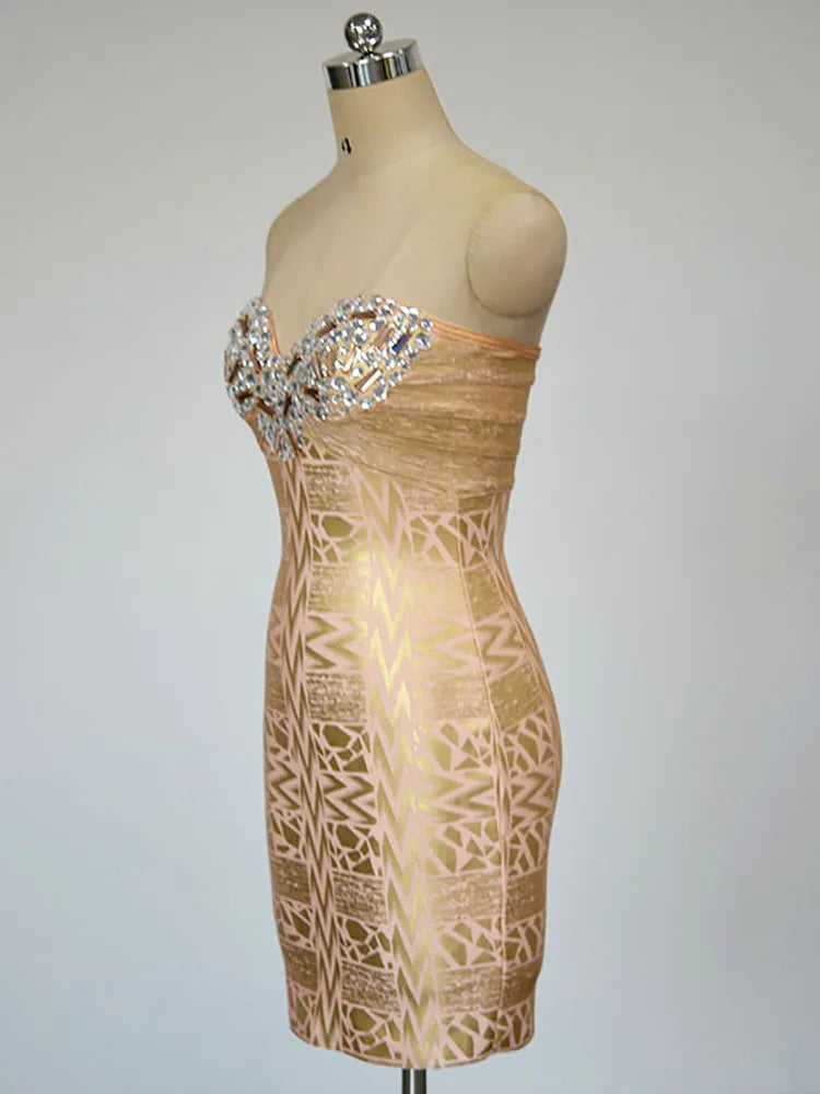 Beige strapless dress with intricate pattern and embellishments on a mannequin against a plain background