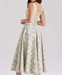 Floral dress with lace-up back on a plain background