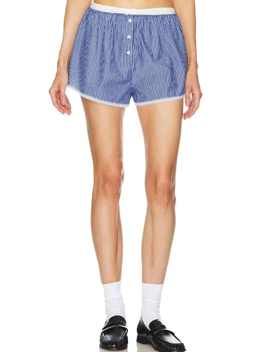 Person wearing blue and white striped shorts on a white background
