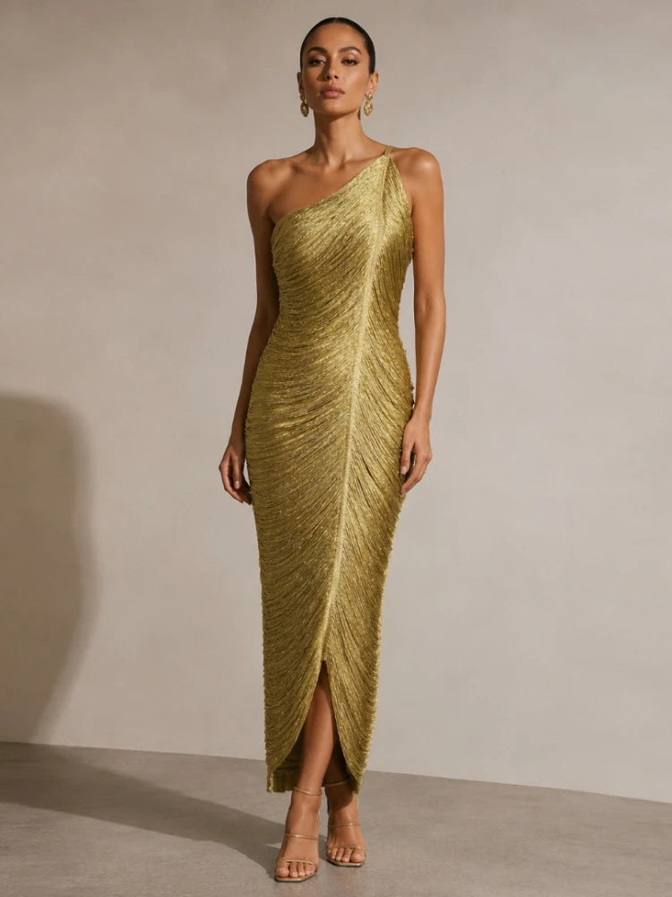 Close-up of gold fringe detailing on one-shoulder dress