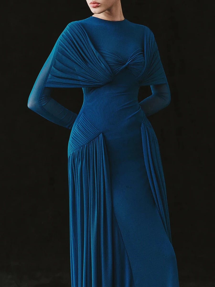 Blue evening gown with a draped design on a black background