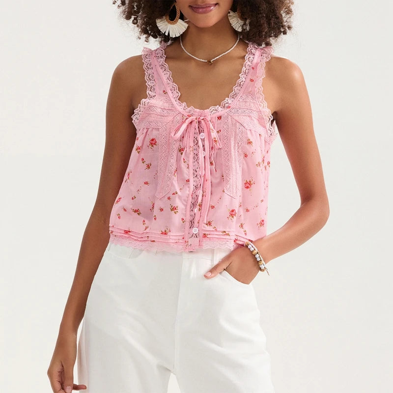 Woman wearing a pink lace top with floral patterns on a white background