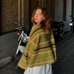 Woman from behind wearing a green striped knit cardigan