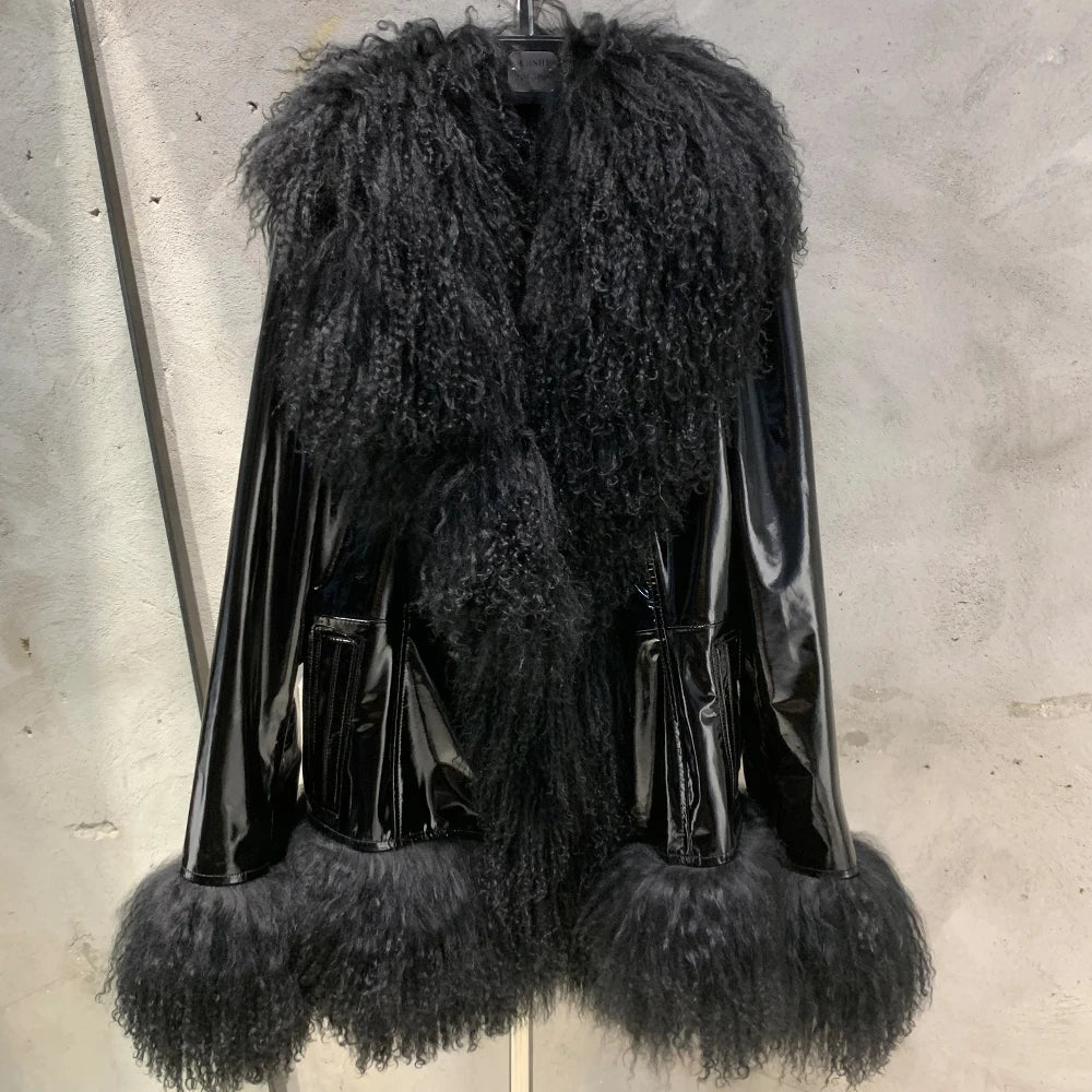 Black fur-trimmed leather jacket on a concrete wall background